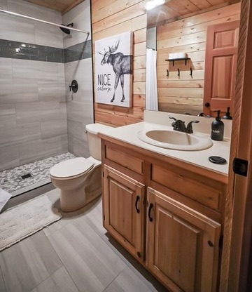 Second bathroom with a walk-in shower, wood vanity and mountain-lodge finishes