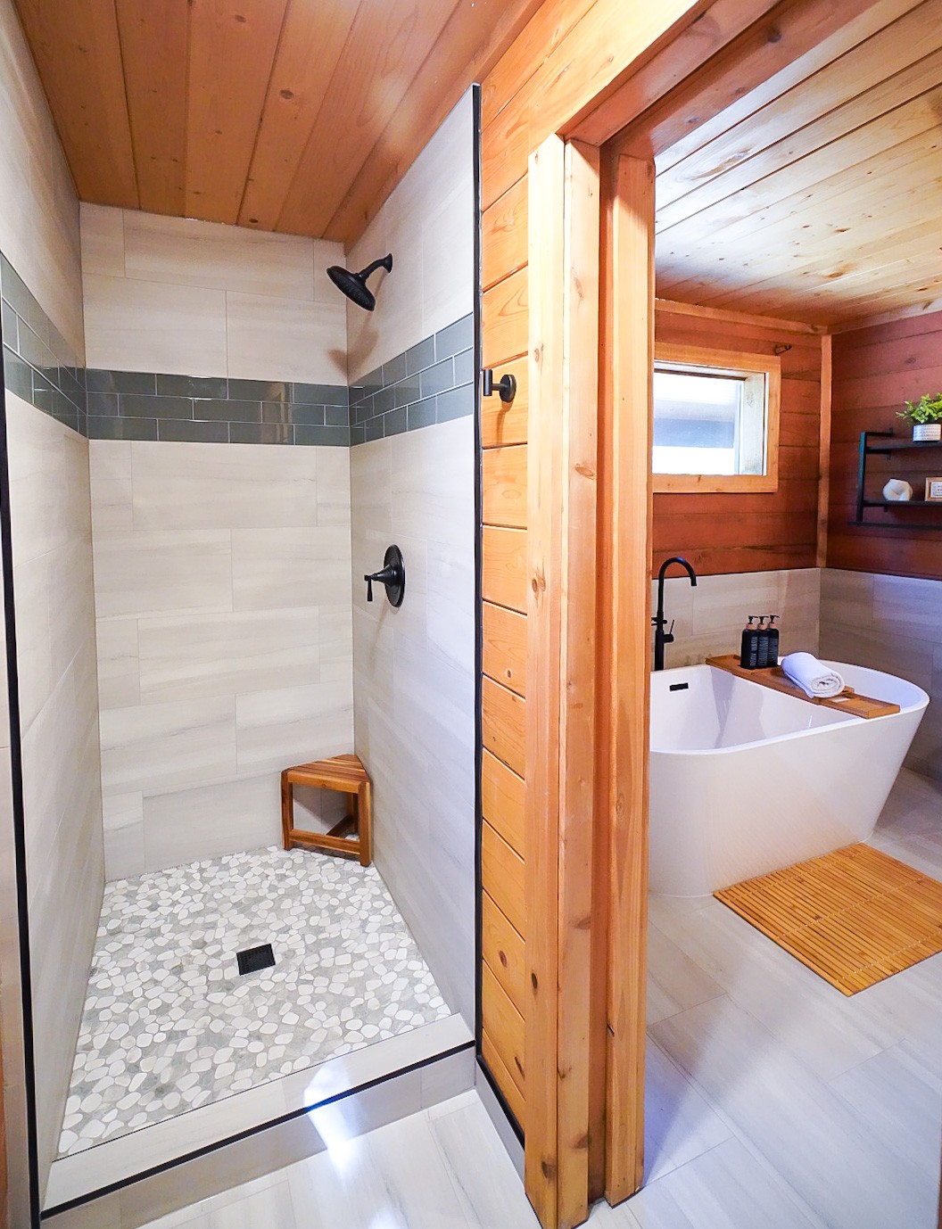 Tiled walk-in shower beside the freestanding soaking tub