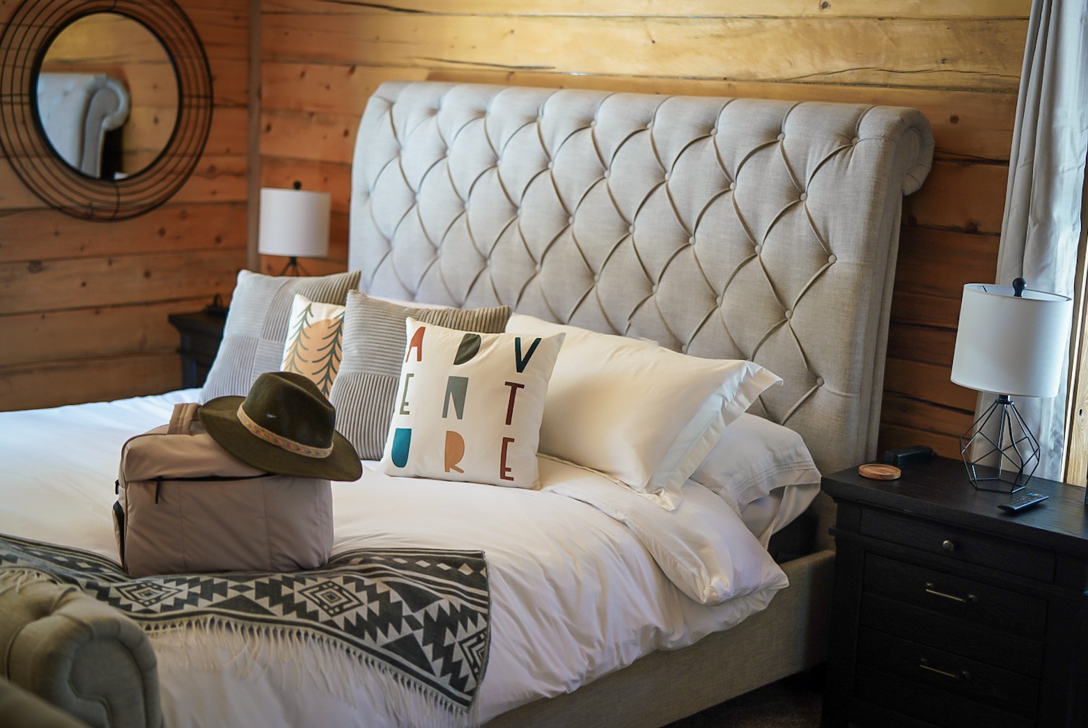 Layered linens and adventure pillows on the second king bed