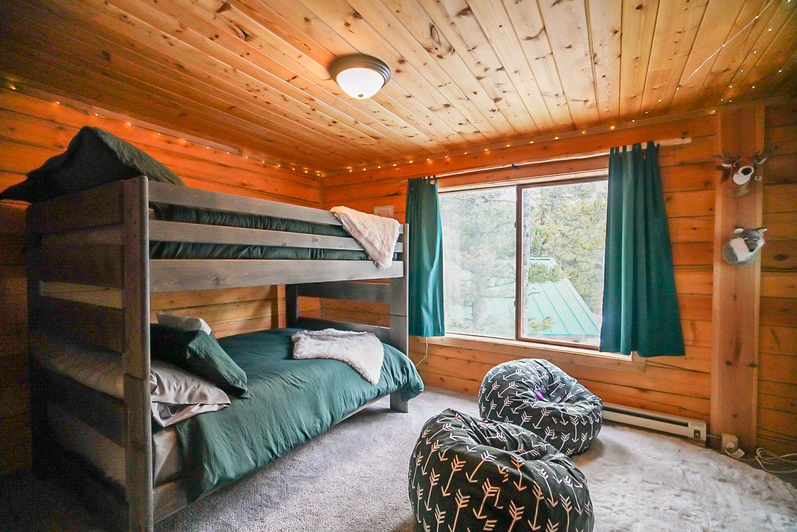 Bunk beds with layered throws and mountain art in the kids' room