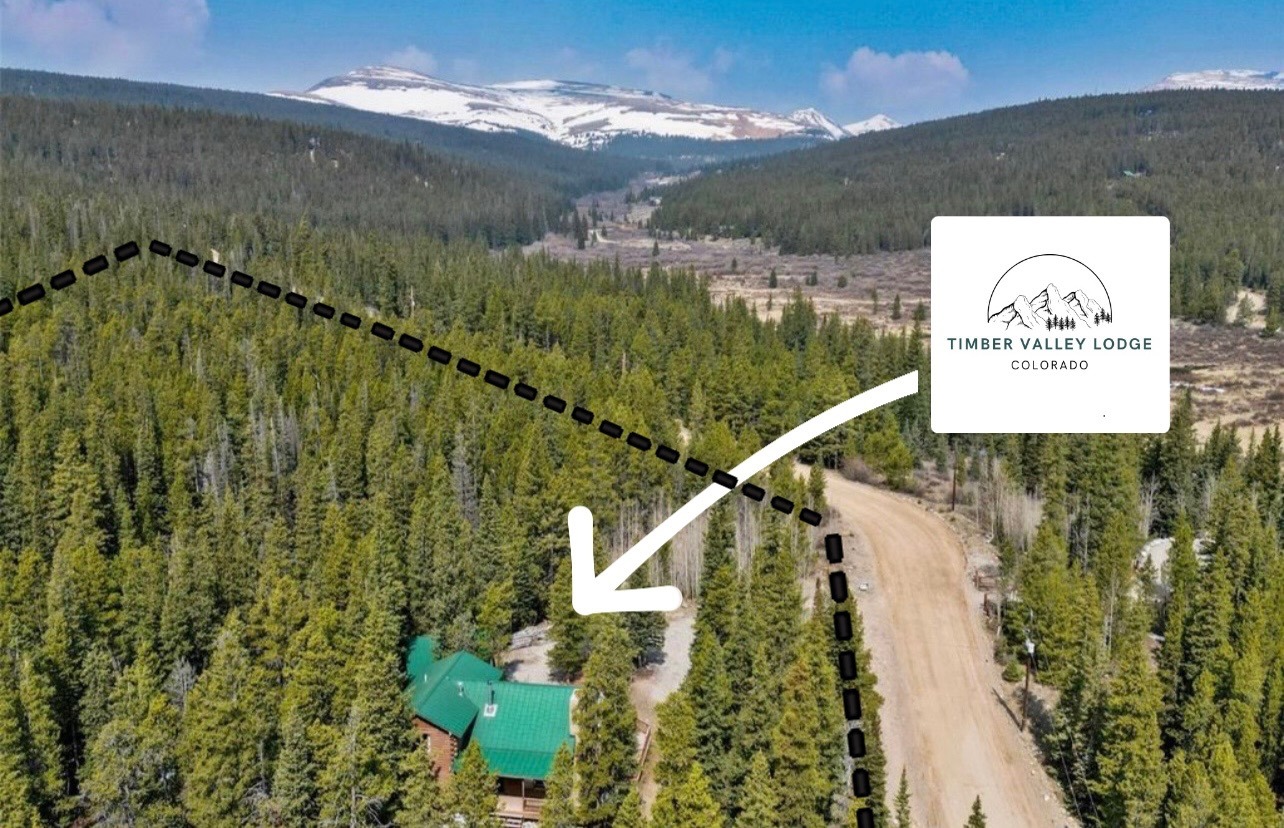 Aerial view showing the lodge tucked into the forest below the Mosquito Range