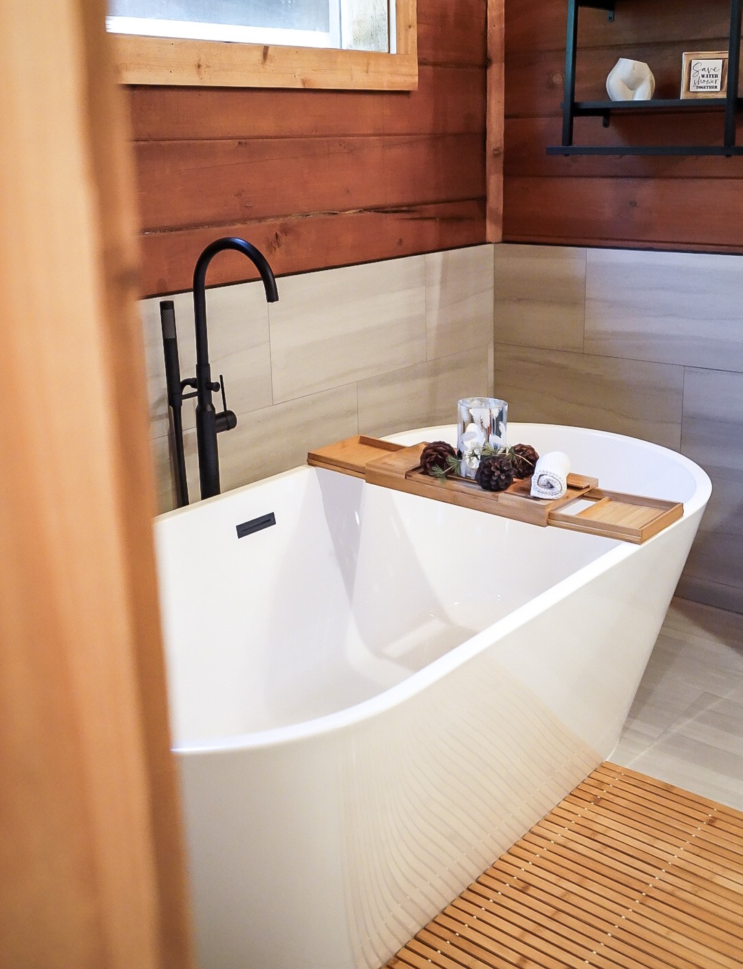 Freestanding soaking tub facing the snowy forest